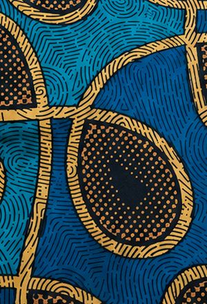 Close crop of teal wax print with gold circle motif